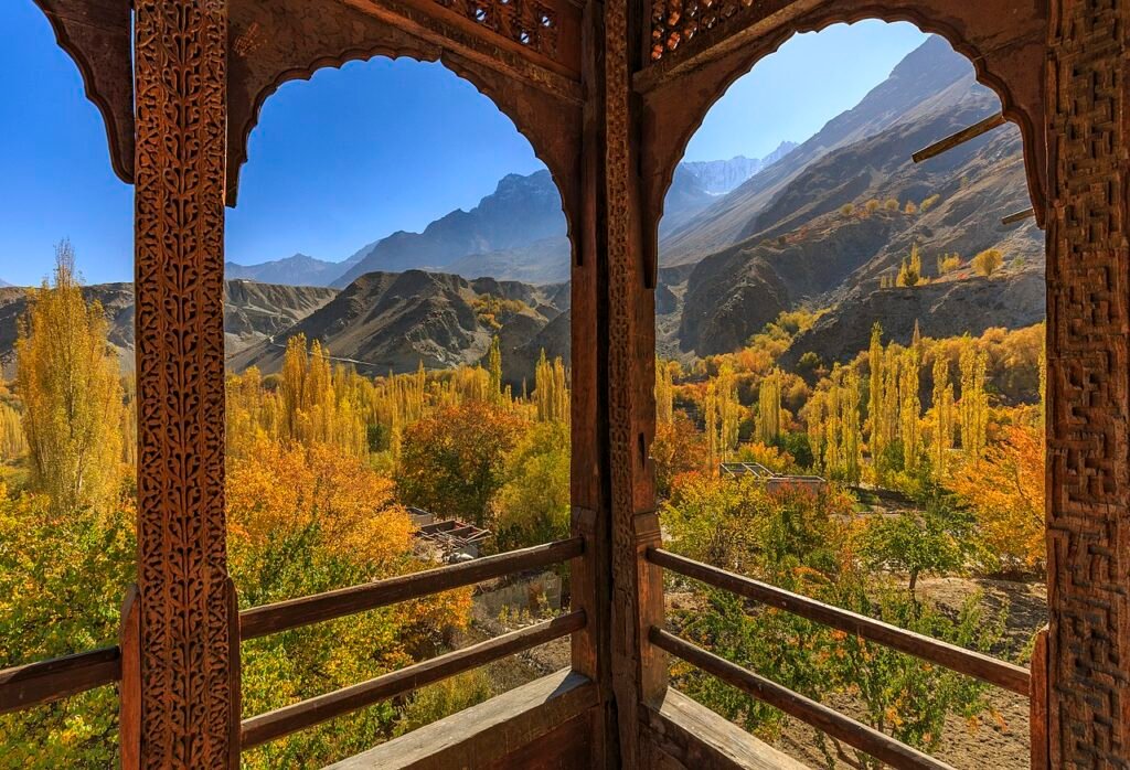Autumn view of Khaplu Valley through the carved balcony of Khaplu Palace, Gilgit-Baltistan