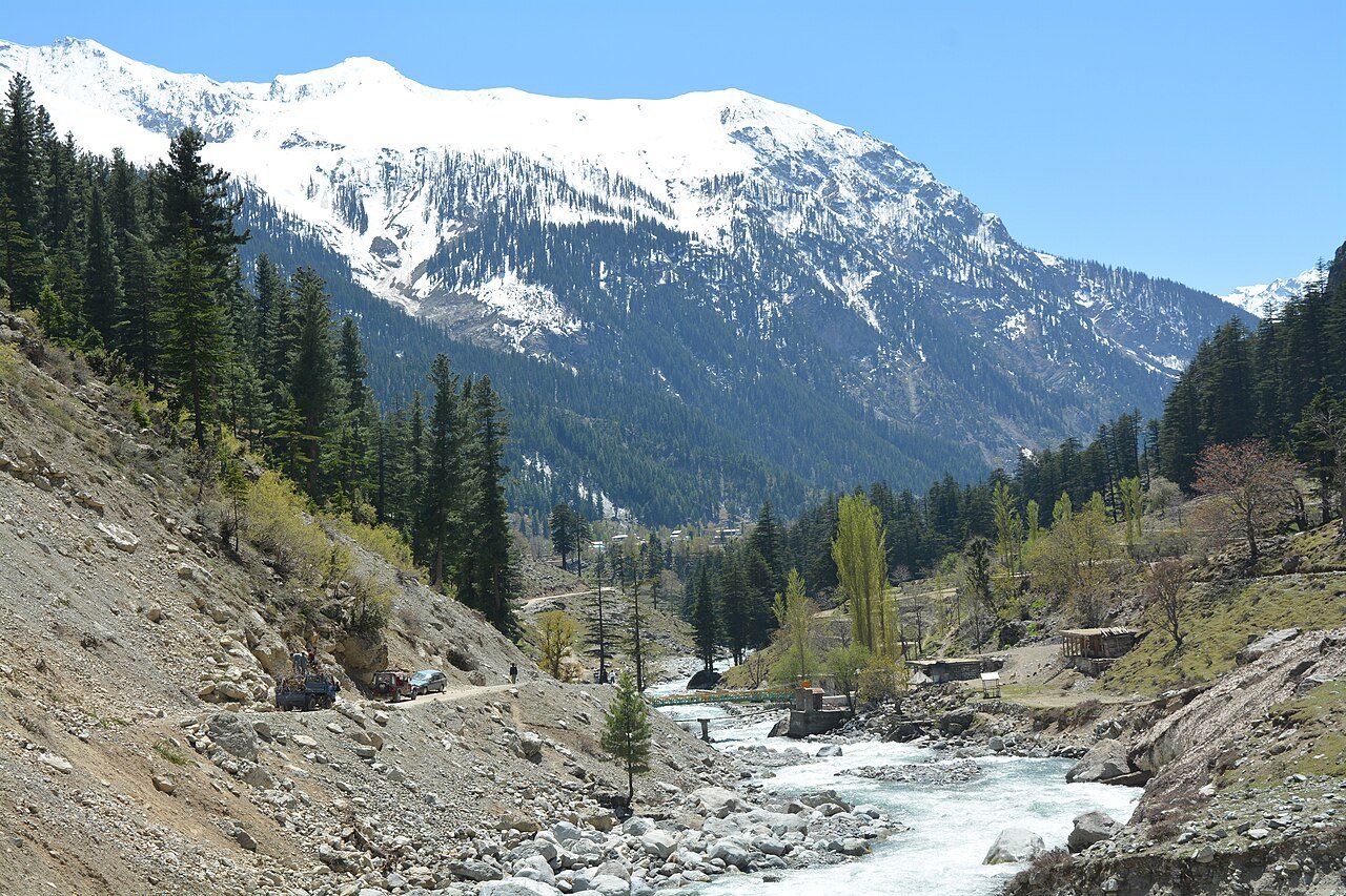 Swat River below snowy mountains in Swat Valley, Pakistan