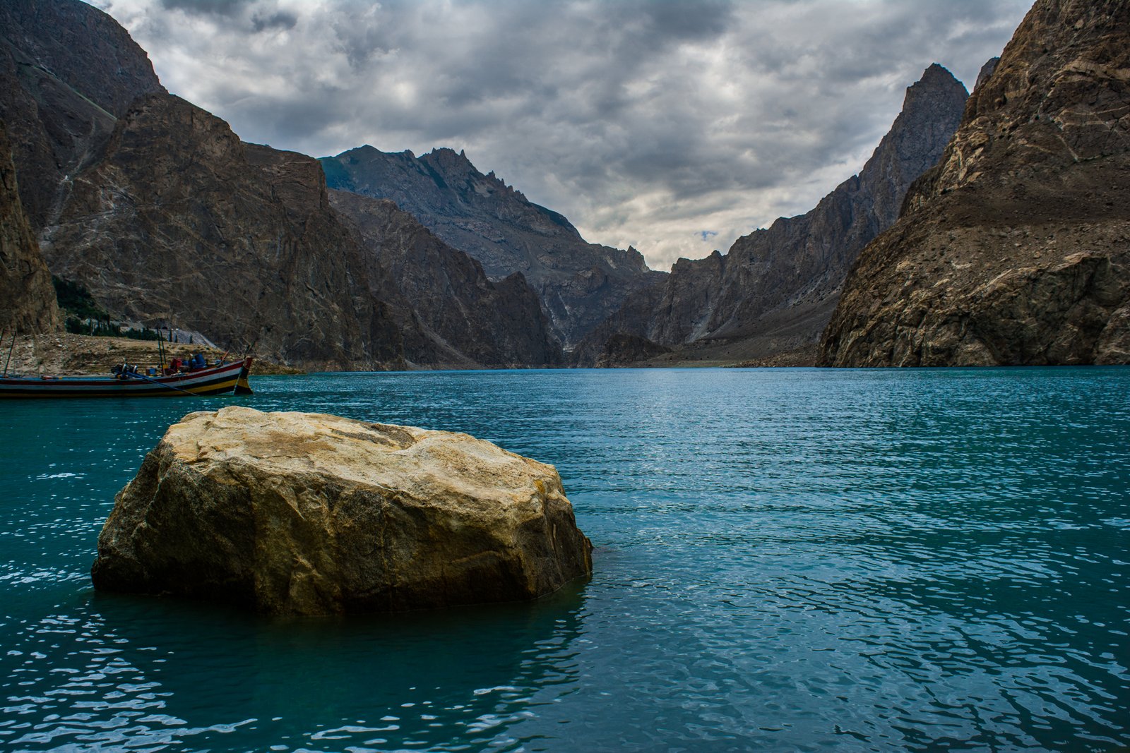 Turquoise Attabad Lake beneath mountains in Hunza Valley, Pakistan