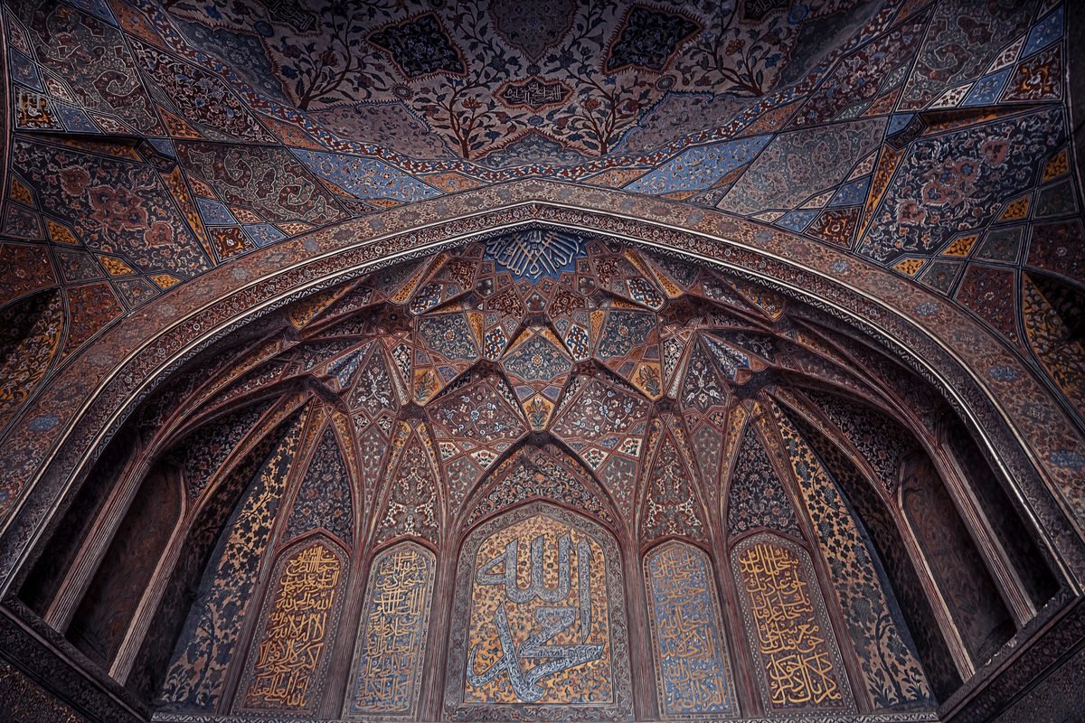 Ornate tilework and painted arches inside Wazir Khan Mosque in Lahore, Pakistan